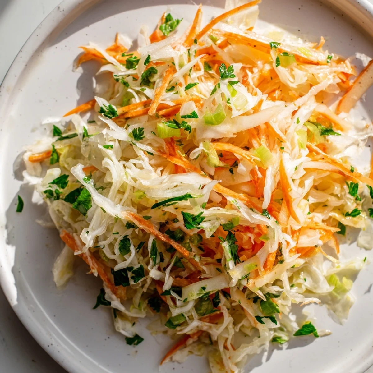 Crisp sauerkraut and apple slaw served in a vibrant bowl, garnished beautifully.  